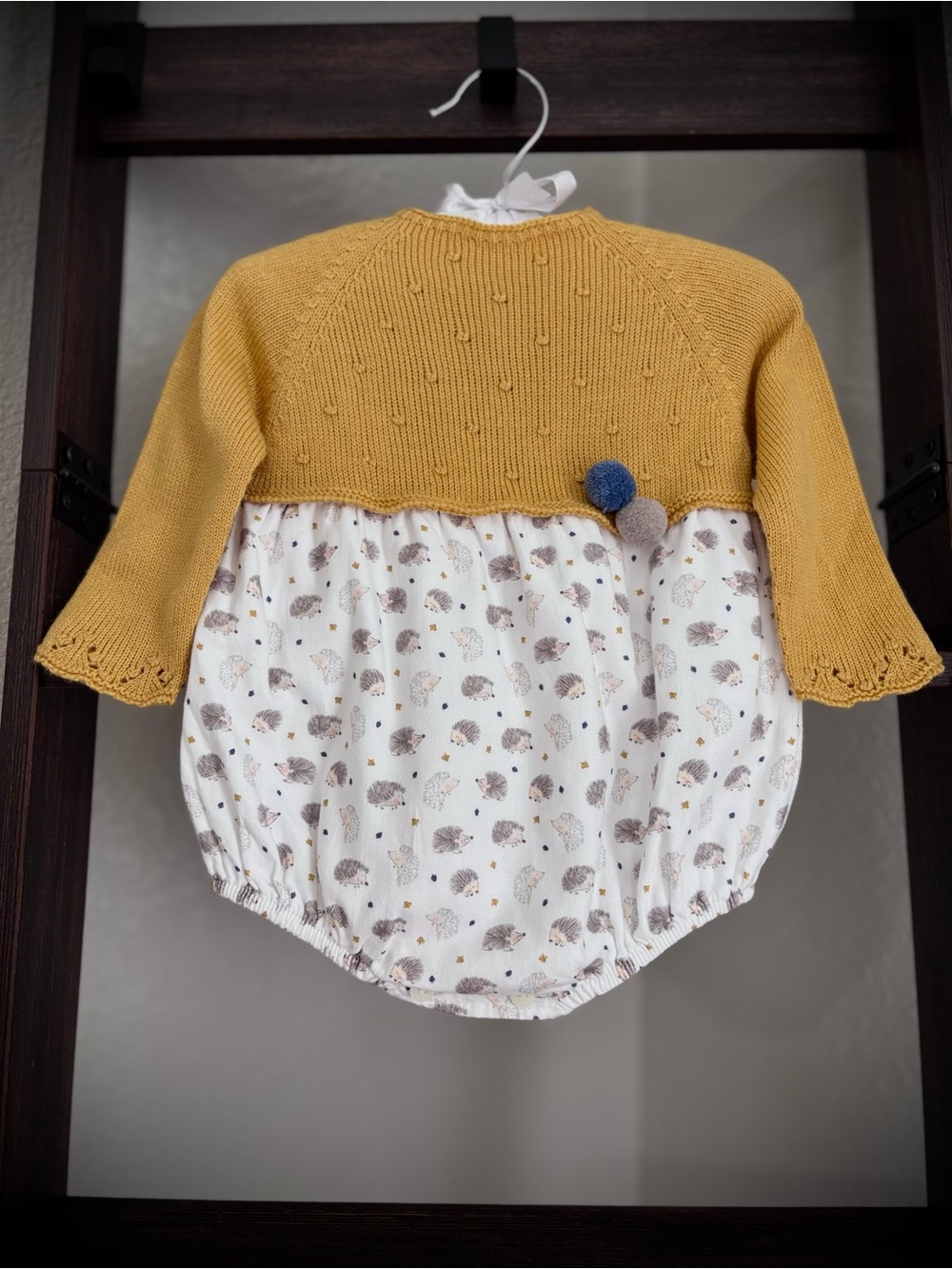Cotton knit rompers with a forest print.